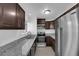 Modern kitchen with stainless steel appliances, granite countertops, and ample cabinet space at 5029 Spencer St # D, Las Vegas, NV 89119