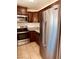 Kitchen features stainless appliances, granite countertops and dark wood cabinets at 5029 Spencer St # D, Las Vegas, NV 89119