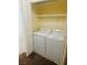 Laundry closet with white washer and dryer and white wire shelf storage above at 5029 Spencer St # D, Las Vegas, NV 89119