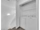 Bright laundry room with a full size washer and dryer and open closet with wire shelving at 5029 Spencer St # D, Las Vegas, NV 89119