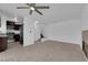 Open-concept living room and kitchen with modern appliances, tile floors, and staircase at 5029 Spencer St # D, Las Vegas, NV 89119
