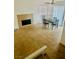 Open concept living room with tan tile flooring, modern fan, tile fireplace and dining area at 5029 Spencer St # D, Las Vegas, NV 89119