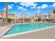 Large community pool with clear water, palm trees, and inviting outdoor common areas at 5029 Spencer St # D, Las Vegas, NV 89119