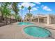 Community pool and hot tub surrounded by lush landscaping and inviting lounge seating at 5029 Spencer St # D, Las Vegas, NV 89119