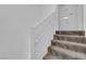 Interior view of a carpeted staircase with white walls and access to upper floor bathroom at 5029 Spencer St # D, Las Vegas, NV 89119