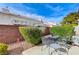 Backyard with a patio table & chairs and a small rock garden area at 5171 Briar Patch Way, Las Vegas, NV 89118