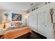 Bedroom featuring a comfortable queen-sized bed, a warm lamp, and decorative items above the sliding closet at 5171 Briar Patch Way, Las Vegas, NV 89118