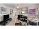 Charming room with unique pinball machine, modern television, neutral tile flooring, and ample natural light at 5171 Briar Patch Way, Las Vegas, NV 89118