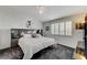 Bedroom with a ceiling fan and large windows with plantation shutters offering natural light at 5171 Briar Patch Way, Las Vegas, NV 89118