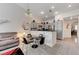 Bright dining area with modern lighting and comfortable seating, flowing into the kitchen and living room at 5171 Briar Patch Way, Las Vegas, NV 89118