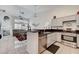 Bright kitchen featuring stainless steel appliances, granite countertops, and an open layout to the living area at 5171 Briar Patch Way, Las Vegas, NV 89118