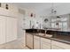 Kitchen with granite countertops, stainless steel dishwasher, and open layout to the adjacent living room at 5171 Briar Patch Way, Las Vegas, NV 89118