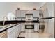 A stylish kitchen showcasing stainless steel appliances, light cabinetry, and sleek granite countertops at 5171 Briar Patch Way, Las Vegas, NV 89118