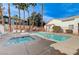 Community pool and jacuzzi with palm trees and lounge chairs, perfect for relaxation at 5171 Briar Patch Way, Las Vegas, NV 89118