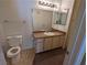 Bright bathroom featuring a single sink vanity, large mirror and standard toilet at 555 E Silverado Ranch Blvd # 2147, Las Vegas, NV 89183