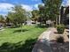 Beautiful exterior shot of the apartments surrounded by lush green landscaping and trees at 555 E Silverado Ranch Blvd # 2147, Las Vegas, NV 89183