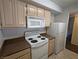 Well-lit kitchen with a white oven, microwave, fridge, and wooden cabinets at 555 E Silverado Ranch Blvd # 2147, Las Vegas, NV 89183