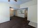 Open-concept living area with view into kitchen, featuring brown carpet and neutral paint scheme at 555 E Silverado Ranch Blvd # 2147, Las Vegas, NV 89183