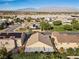 Aerial view of homes in a well-maintained community with mountain views in the distance at 6141 Markleham Ave, Las Vegas, NV 89130