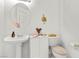 Powder room featuring a pedestal sink, toilet and decorative accents at 6141 Markleham Ave, Las Vegas, NV 89130