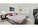 Bedroom featuring a bed with a padded headboard and sleek black matching nightstands at 6141 Markleham Ave, Las Vegas, NV 89130
