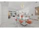 Bright dining area features a modern chandelier and a glass top table, perfect for entertaining and Gathering gatherings at 6141 Markleham Ave, Las Vegas, NV 89130