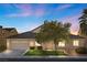 Charming single-story home with a well-manicured front lawn, mature tree, and a two-car garage, under a beautiful sky at 6141 Markleham Ave, Las Vegas, NV 89130