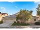 Charming single-story home with a well-manicured front lawn, mature tree, and a two-car garage at 6141 Markleham Ave, Las Vegas, NV 89130