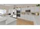 Bright kitchen features white cabinets, stainless steel appliances and a kitchen island at 6141 Markleham Ave, Las Vegas, NV 89130