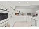 Bright and modern kitchen featuring sleek white cabinetry and countertops, and contemporary appliances at 6141 Markleham Ave, Las Vegas, NV 89130