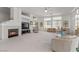 Spacious living room with a fireplace, comfortable seating, and natural light at 6141 Markleham Ave, Las Vegas, NV 89130
