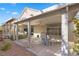 Covered patio offers an outdoor table setting and serene desert landscaping at 6141 Markleham Ave, Las Vegas, NV 89130