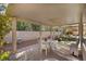 Covered patio area with multiple seating areas and a ceiling fan at 6141 Markleham Ave, Las Vegas, NV 89130