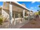 Covered patio with an outdoor table, chairs, and desert landscaping in a peaceful setting at 6141 Markleham Ave, Las Vegas, NV 89130