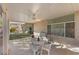 Covered patio with ample seating area, artificial grass, and desert landscape at 6141 Markleham Ave, Las Vegas, NV 89130
