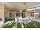 Covered patio with ample seating and artificial grass at 6141 Markleham Ave, Las Vegas, NV 89130