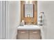Modern half bathroom with sleek vanity and decorative wood accent wall at 7115 Hickory Post Ave, Las Vegas, NV 89179