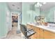 Well-lit bathroom with dual vanities, modern fixtures, and a connected walk-in closet at 7115 Hickory Post Ave, Las Vegas, NV 89179