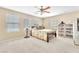 Bright bedroom featuring a comfortable bed, ceiling fan and three large windows at 7115 Hickory Post Ave, Las Vegas, NV 89179