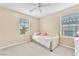 Bright bedroom featuring two windows that provide natural light, and a comfortable bed at 7115 Hickory Post Ave, Las Vegas, NV 89179