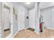 Inviting hallway with light-colored walls and wood-look floors, leading to various rooms at 7115 Hickory Post Ave, Las Vegas, NV 89179