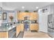 Beautiful kitchen with stainless steel appliances, light wood cabinets, and modern backsplash at 7115 Hickory Post Ave, Las Vegas, NV 89179