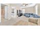 Spacious living room with plush blue sofa and ceiling fan, perfect for relaxing at 7115 Hickory Post Ave, Las Vegas, NV 89179