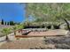 Landscaped backyard with deck and lounge seating perfect for entertaining at 7140 Palmyra Ave, Las Vegas, NV 89117