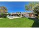 Spacious backyard with a pool, jacuzzi, and well-maintained lawn at 7140 Palmyra Ave, Las Vegas, NV 89117