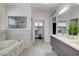 Bright bathroom features marble accents, a soaking tub, and a double vanity at 7140 Palmyra Ave, Las Vegas, NV 89117