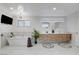 Well-appointed bathroom featuring a large vanity, stylish mirrors, and a soaking tub, blending luxury and functionality at 7140 Palmyra Ave, Las Vegas, NV 89117