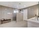 Modern bathroom featuring light-grey tiling, a glass-enclosed shower, and double vanity at 7140 Palmyra Ave, Las Vegas, NV 89117