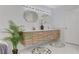 Bright bathroom featuring a modern vanity with dual sinks and flower-themed rugs at 7140 Palmyra Ave, Las Vegas, NV 89117