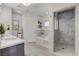 Luxurious bathroom featuring marble shower, soaking tub, and vanity with double sinks at 7140 Palmyra Ave, Las Vegas, NV 89117